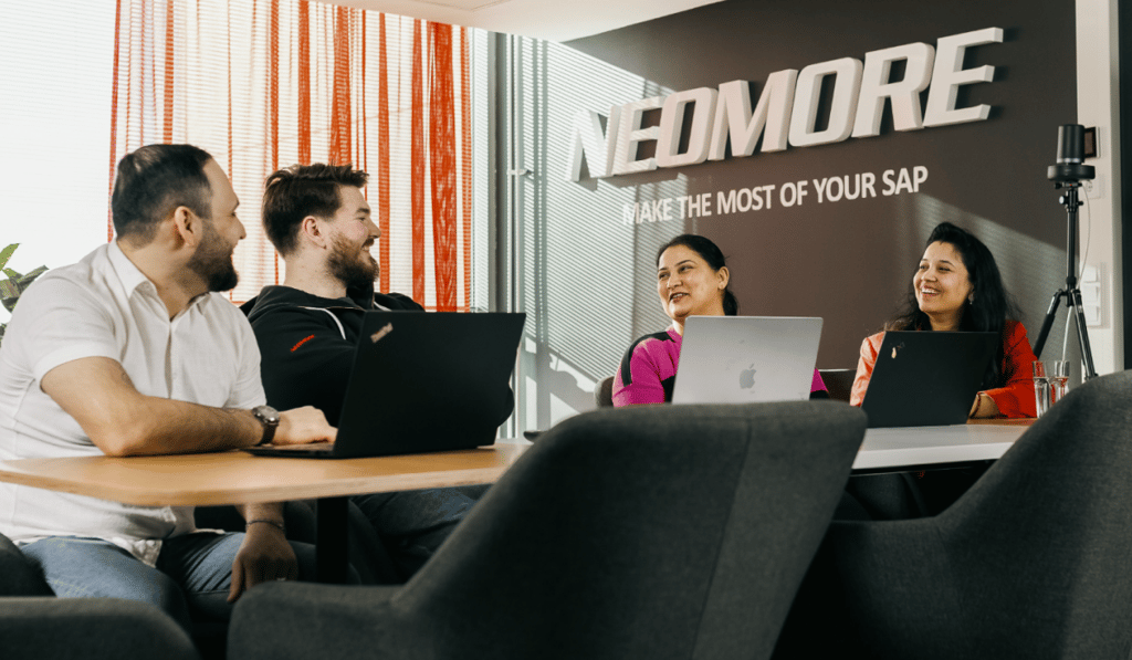 Neomore employees in a meeting room
