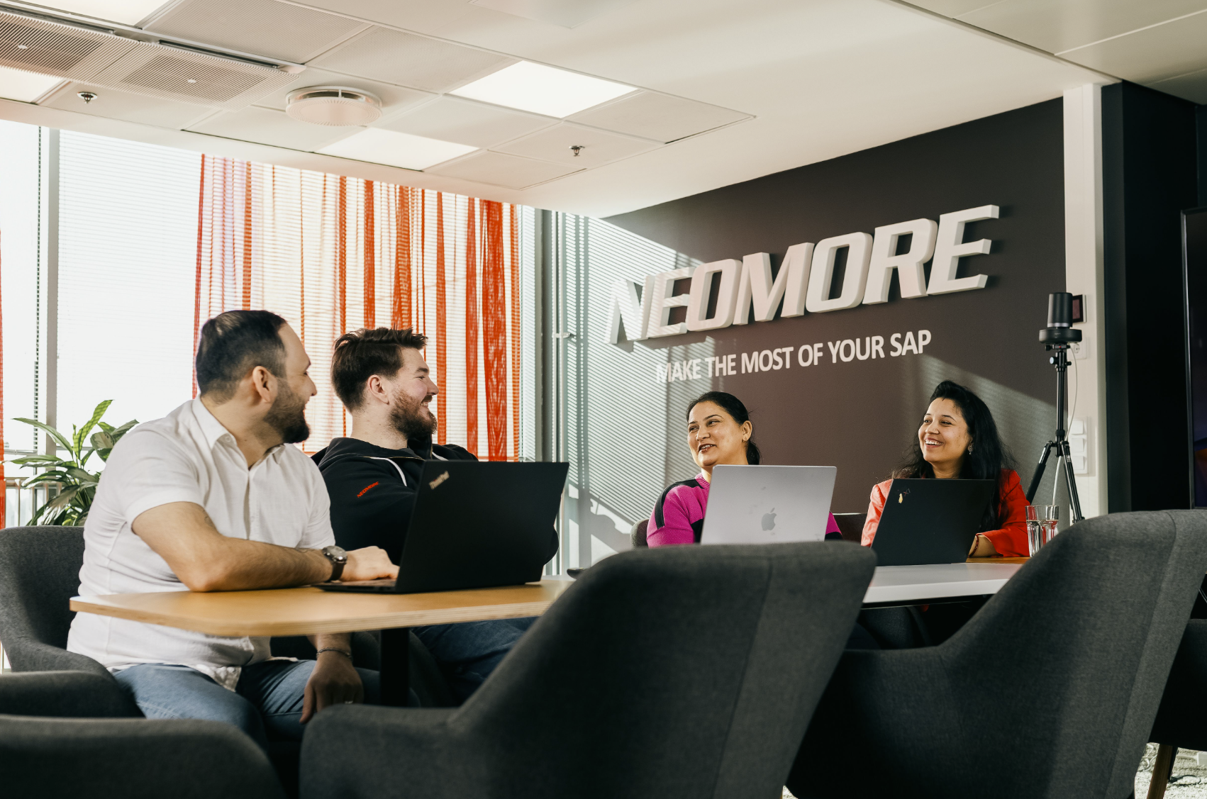 Neomore's SAP consultants in a meeting room